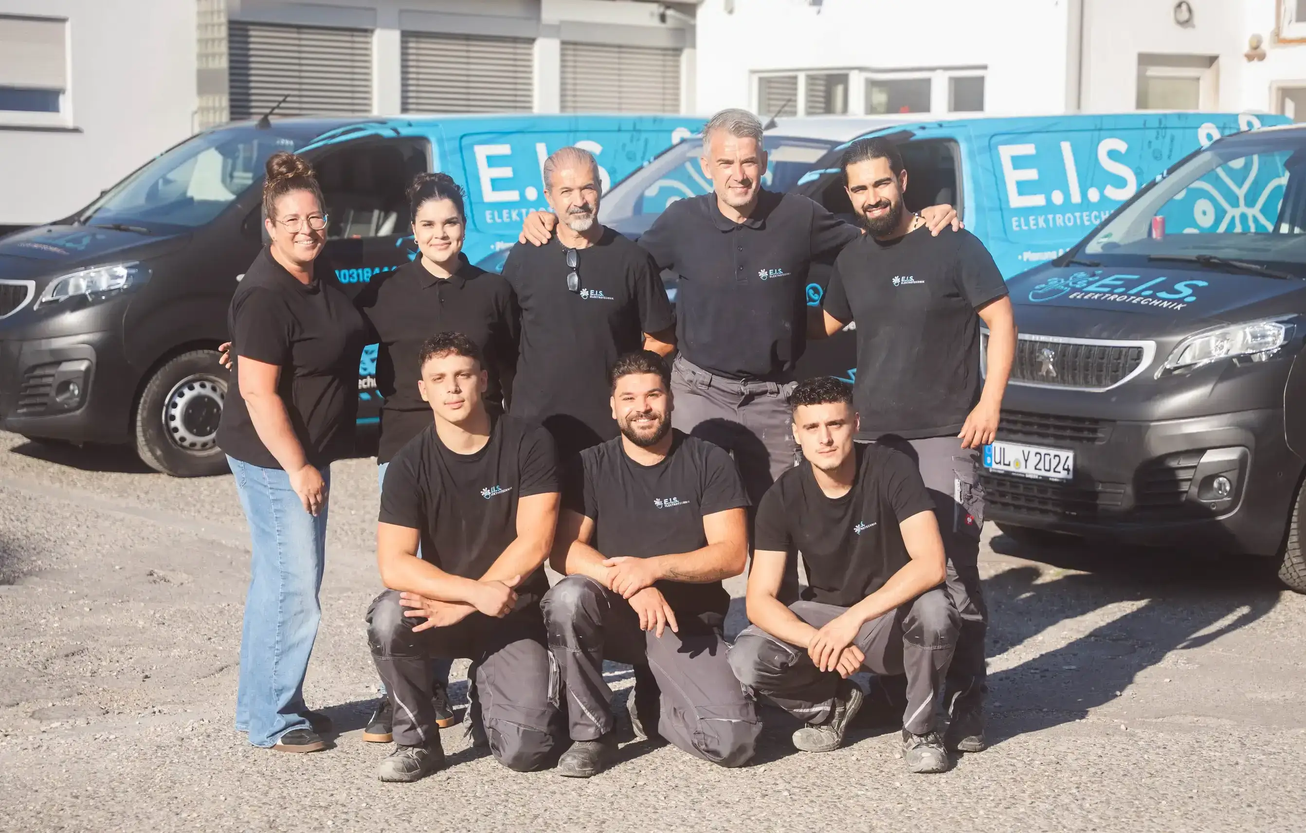 Das Team von E.I.S. Elektrotechnik vor den Servicefahrzeugen